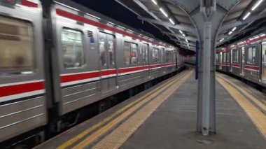 Jakarta, Endonezya, 27 Eylül 2024. Jakarta Kota tren istasyonunda gece faaliyetleri. Yolcuları gidecekleri yere götürmek için istasyondan ayrılan banliyö hattı görülüyor. Sağ tarafta, yolcu bekleyen banliyö hattı görülüyor..