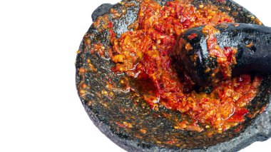 Beyaz arka planda izole edilmiş ev yapımı sıcak sambal ya da kırmızı biber sosu, taş havan ve tokmak, otantik Endonezya geleneksel mutfak aletleri