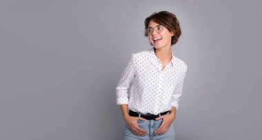 Zeki resmi gömlekli ve gözlüklü, kendine güveni tam bir çalışan şirket avukatı kadın. Ofiste çalış. Gri arka plan stüdyosunda izole edilmiş şık saç stiline sahip bir kadın..