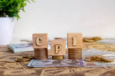 CPI, consumer price index symbol. wooden block with words CPI, consumer price index on dollar bills. Business and CPI, consumer price index concept. clipart