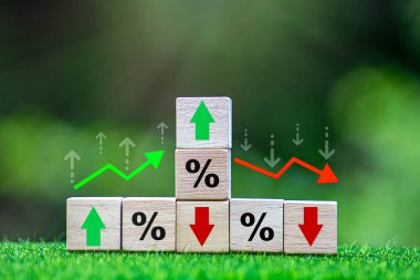 Business and finance concept. Economic and business analysis, risk management. Interest rate, stocks, financial, ranking, mortgage and loan rates. Wooden cubes with percent, up or down arrow icons. clipart