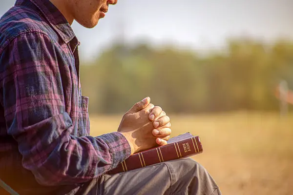 Silhouette of woman kneeling down praying for worship God at sky background. Christians pray to jesus christ for calmness. In morning people got to a quiet place and prayed. copy space