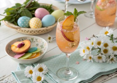 A sparkling peach Bellini in a tall champagne flute is garnished with a slice of fresh peach and a sprig of mint. The pastel Easter theme is enhanced by the surrounding decorations of colorful eggs, fresh daisies, and a soft tablecloth in spring hues clipart