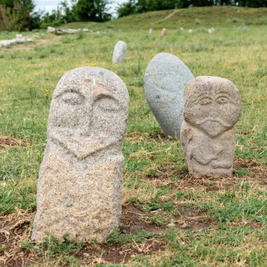 Historical stone sculptures near Old Burana tower that depict various figures and scenes from Kyrgyz history and culture. These sculptures provide insight into country's rich history and traditions