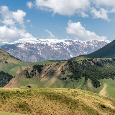 Kyrgyzstan nature green landscape with vast mountains. Kyrgyzstan is a landlocked country located in central Asia, known for its rugged, mountainous terrain and verdant grasslands.