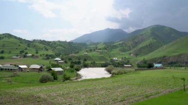 Kyrgyzstan nature green landscape with vast mountains. Kyrgyzstan is a landlocked country located in central Asia, known for its rugged, mountainous terrain and verdant grasslands.