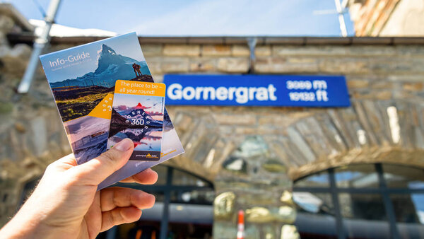 Zermatt, Switzerland - 24 October 2023: Gornergrat booklet and ticket in hand at Gornergrat station. Gornergrat is a mountain ridge in the Swiss Alps, offers breathtaking panoramic views