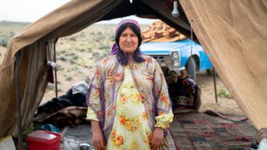 Shiraz, Iran - 5 May 2019: Portrait of a Qashqai nomadic woman by her tent. Qashqai are nomadic people living in temporary villages. clipart