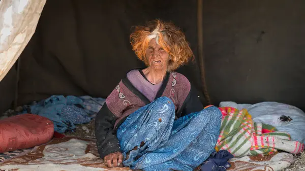 stock image Shiraz, Iran - 5 May 2019: Portrait of a Qashqai nomadic old woman sitting inside her tent. Qashqai are nomadic people living in temporary villages.