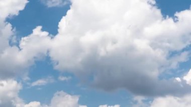 Yazın mavi gökyüzünde hareket eden beyaz bulutların zamanlanmış videosu. Işığın ve rengin dinamik oyunu doğanın değişen, bulutlu havadaki güzelliğini gözler önüne seriyor.