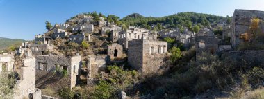 Kayakoy ghost town near Fethiye, Mugla, Turkey. Abandoned Greek village with crumbling stone houses, historic ruins, and a hauntingly beautiful hillside setting. clipart