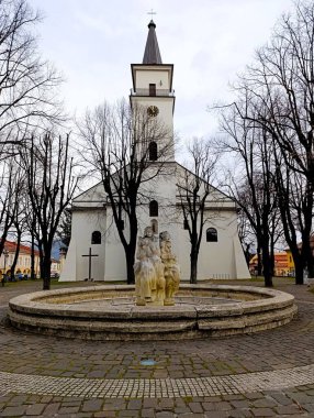 winter view of catholic church on the main square in european town  clipart