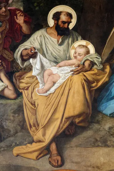 Paris, FRANCE - 09-12-2024: Bebek İsa 'yı kollarında tutan Aziz Yusuf' un eski tablosu.
