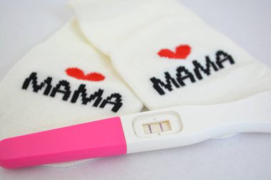 announcing pregnancy in a cute way, mommy and mommy socks together with a positive pregnancy test, lmbtq, pr1de clipart