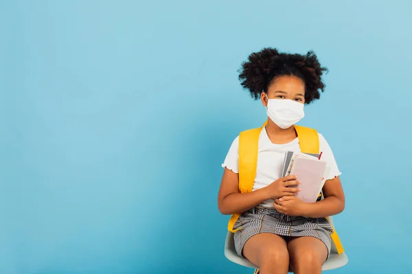 Happy African American Schoolgirl Mask Sitting Chair Blue Background Copy — Stock Photo, Image