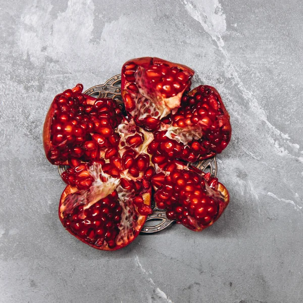 stock image Fresh, cut pomegranate fruit, on a gray stone background, food concept, top view