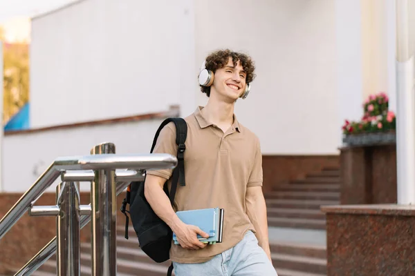 Attractive Curly Haired Young Man Headphones Books University College Student — Stock Photo, Image