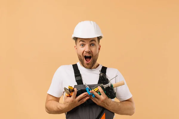 Positive Male Repairman Home Holding Various Repair Tools Beige Background — Stock Photo, Image