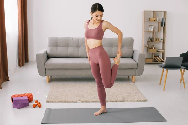 stock image Attractive and healthy young woman doing exercises while resting at home