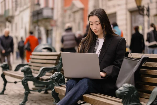 stock image Business freelance young adult asian woman using laptop computer for work. Sitting at outdoor on day. Urban people lifestyle with modern technology.