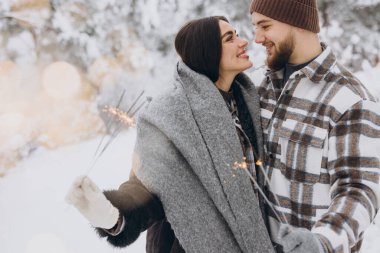 Kış Ormanı 'nda kıvılcımlarla poz veren, Bengal ışıkları tutan, Noel tatillerini birlikte kutlayan,
