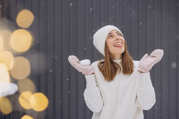 Happy Woman Knitted Mittens Trying Catch Snowflakes Her Tongue Gray — Stock Photo, Image