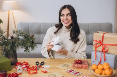 Noel hediye kutularını duygularla paketleyen ya da açan kadın, kapat. Dekor unsurları ve ögeleri olan hazırlıksız hediyeler Noel veya Yeni Yıl DIY paketleme kavramı.