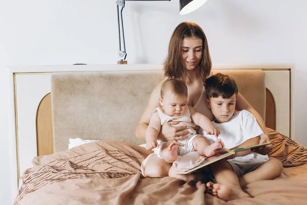 Young Mother Reads Fairy Tale Her Children Boy Little Baby — Stock Photo, Image