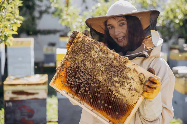 Ευτυχισμένος Χαμογελαστός Θηλυκός Μελισσοκόμος Προστατευτική Στολή Που Κρατά Πλαίσιο Μελισσών — Φωτογραφία Αρχείου