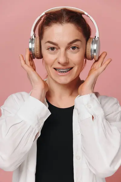 Modern Woman Smiling Braces Her Teeth Listening Music Headphones Pink — Stock Photo, Image
