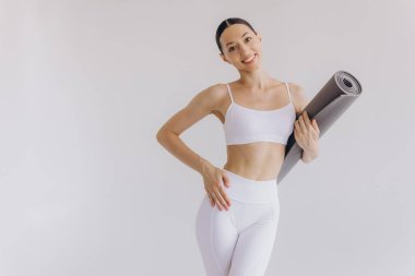 Beyaz arka planda yoga minderi tutan genç kadın panoramik afiş, spor, fitness, meditasyon, yoga dengesi, farkındalık, egzersiz, hobi, sağlıklı yaşam tarzı konsepti