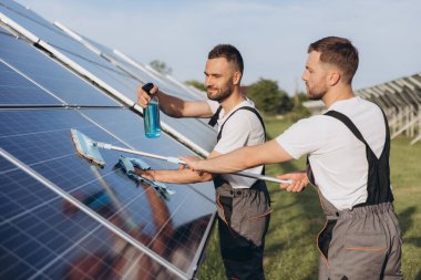 Labor working on cleaning solar panel at solar power plant, Professional cleaning, Solar panels. clipart