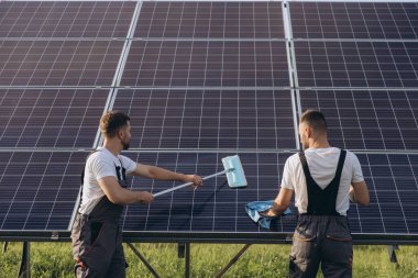 Labor working on cleaning solar panel at solar power plant, Professional cleaning, Solar panels. clipart