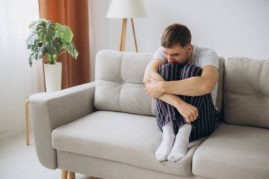 Depresyondaki umutsuz adam zihinsel çöküntü, psikoterapi, pankart boyunca kanepede yatar.