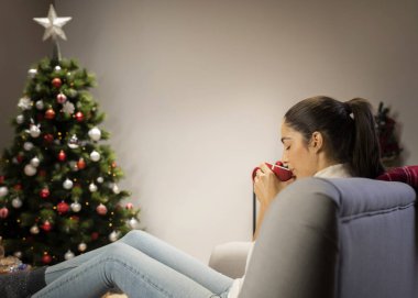 Esmer kadın bardaktan içiyor.