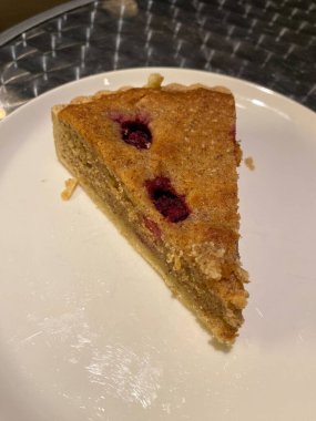 frangipane pie slice with cherries served at restaurant. ready to eat.
