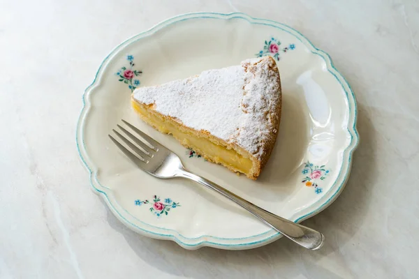 A piece of Custard cream cake with pine nuts. Traditional italian cake - torta della nonna or grandmother\'s cake. Tuscany pastry. ready to eat.