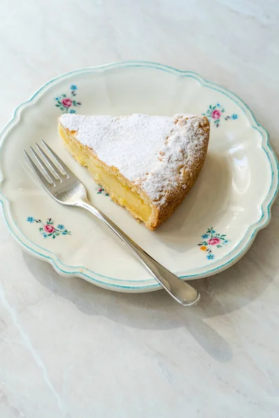 A piece of Custard cream cake with pine nuts. Traditional italian cake - torta della nonna or grandmother\'s cake. Tuscany pastry. ready to eat.