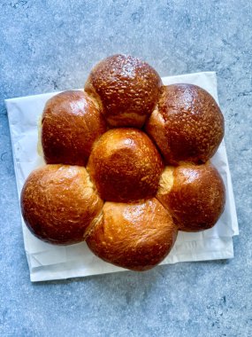 Brioche bread slice showcasing its soft, buttery texture, placed on a clean surface for a high-quality food photo, highlighting its fluffy interior and golden crust. Ready to eat clipart