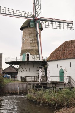 Unique Dutch mill named 'De Kilsdonkse Molen'  is a so called 'Watervluchtmolen', a combined water and wind driven mill in Heeswijk-Dinther. It was reconstructed in 2009. It produces wheet flour and vegetable oils. clipart