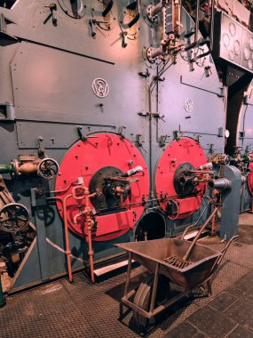 January 5, 2024 - Lemmer, Netherlands: View of the Woudagemaal's historic interior featuring riveted steel steam boiler in a beautifully preserved industrial setting. clipart