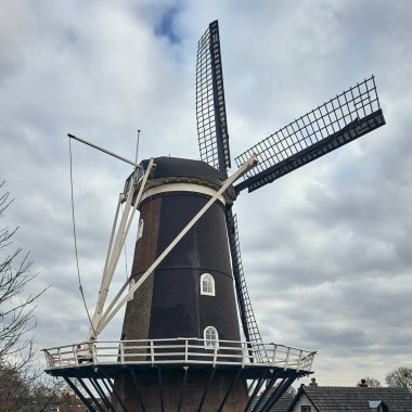 Historic Windmill De Blauwe Reiger in Haaften, Dutch River Landscape with Heritage Charm, showcasing Dutch heritage, architecture, and a serene rural landscape. clipart