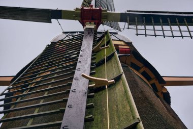 Close-up on the Loenderveense polder mill, a historic drainage windmill, with its windshaft and sail stocks showcasing Dutch water management heritage. clipart