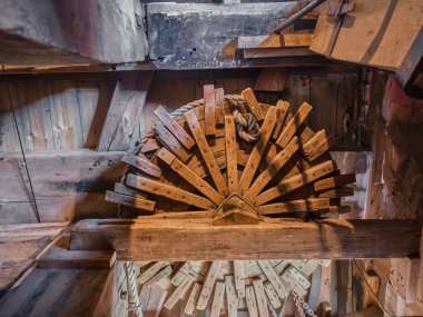 Historic Kockengse Windmill: Interior view of a traditional Dutch windmill showcasing wooden brake wheel gear and rustic wooden construction details. clipart