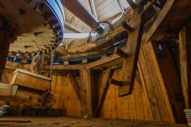 Looking in the cap of the mill with of the wooden gears and beams inside De Korenbloem in Vriescheloo, Groningen, showcasing traditional craftsmanship of mill wrights clipart