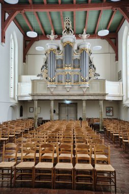 February 12, 2025 - Rolde, Netherlands: The interior of Jacobus Church featuring an ornate organ, balcony, and vaulted ceilings. clipart