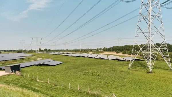 3 Mayıs 2025 - Yerseke-Hollanda: Hollanda enerji geçişi burada hem eski hem de yeni yüksek voltaj hatları ve yakınlardaki demiryolu hatlarıyla çevrili güneş parkları ile görülebilir.