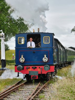 29 Mayıs 2025 - Hoedekenskerke-Hollanda: La Meuse Buharlı Lokomotifi No. 5 'Enkhuizen' Hoedekenskerke istasyonundan kalkan trenle geri geri giderken, sürücü merkez taksi penceresinden dışarı bakarken görüldü.