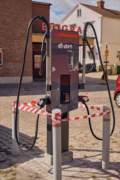 Laholm, Sweden ; August 22, 2025: E.ON Drive dual EV charger newly installed in central Laholm, barrier taped and awaiting commissioning at the public charging station.