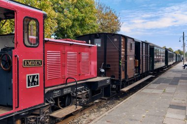 Bruchhausen-Vilsen, Germany ; October 3, 2025: Henschel diesel locomotive Emden V4 prepares a heritage train with baggage and passenger cars during the museum railway open day.